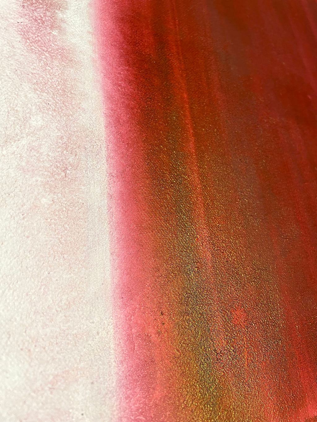 Close-up of a textured surface with red and white colors