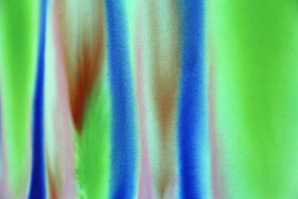 Colorful striped fabric with green, blue, and pink hues.