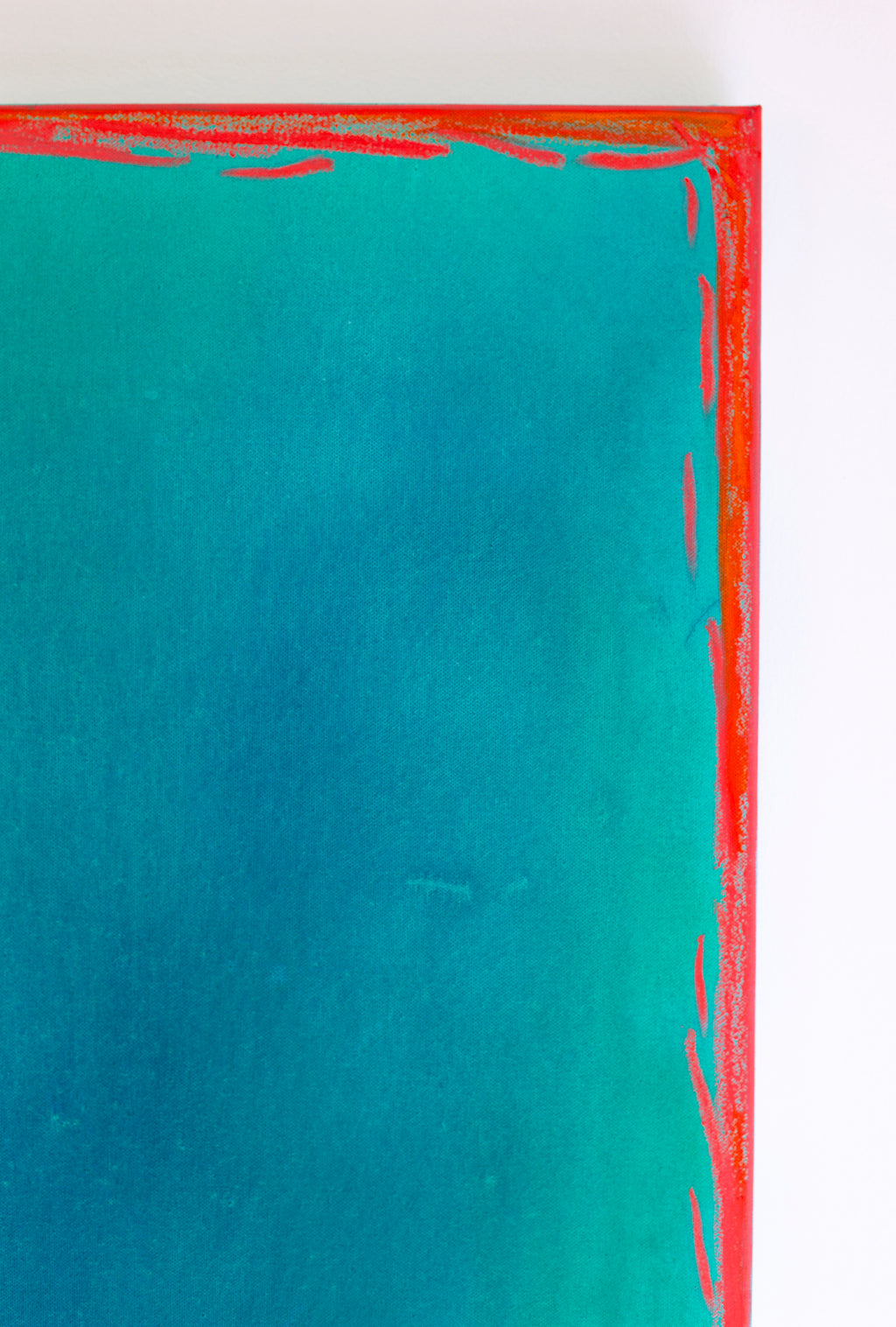 Abstract art piece with a red border and teal center on a white background