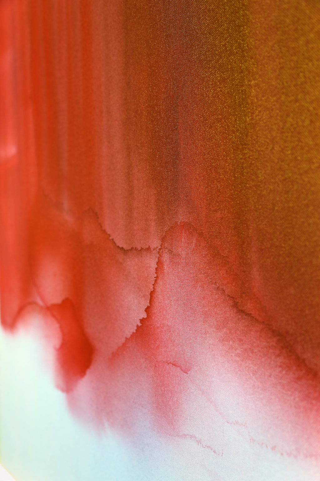 Close-up of a textured surface with red, orange, and white colors.
