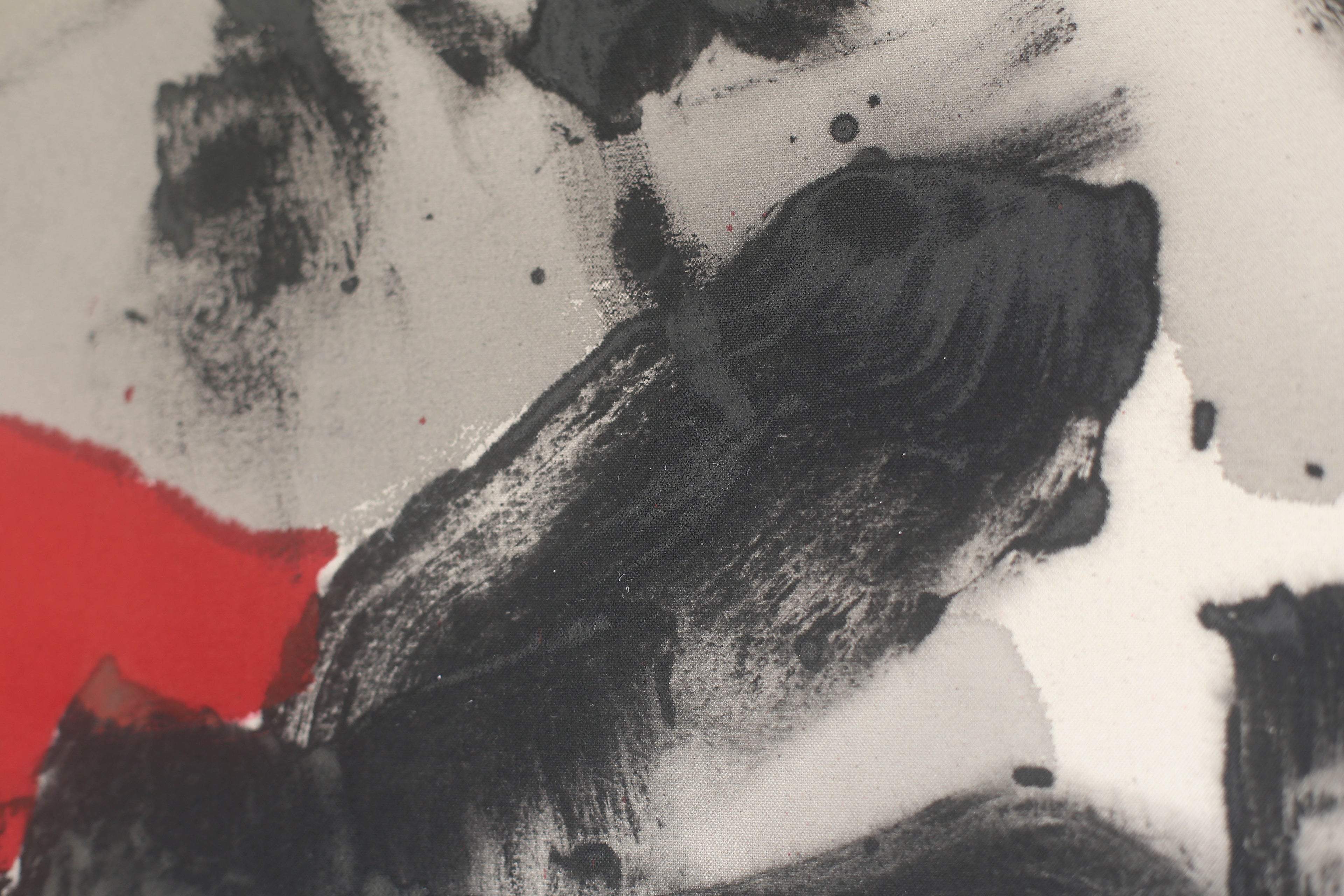 Detail of an abstract painting by Evgenia Makarova. Dry black brushwork over raw canvas, cut by a flat red field.