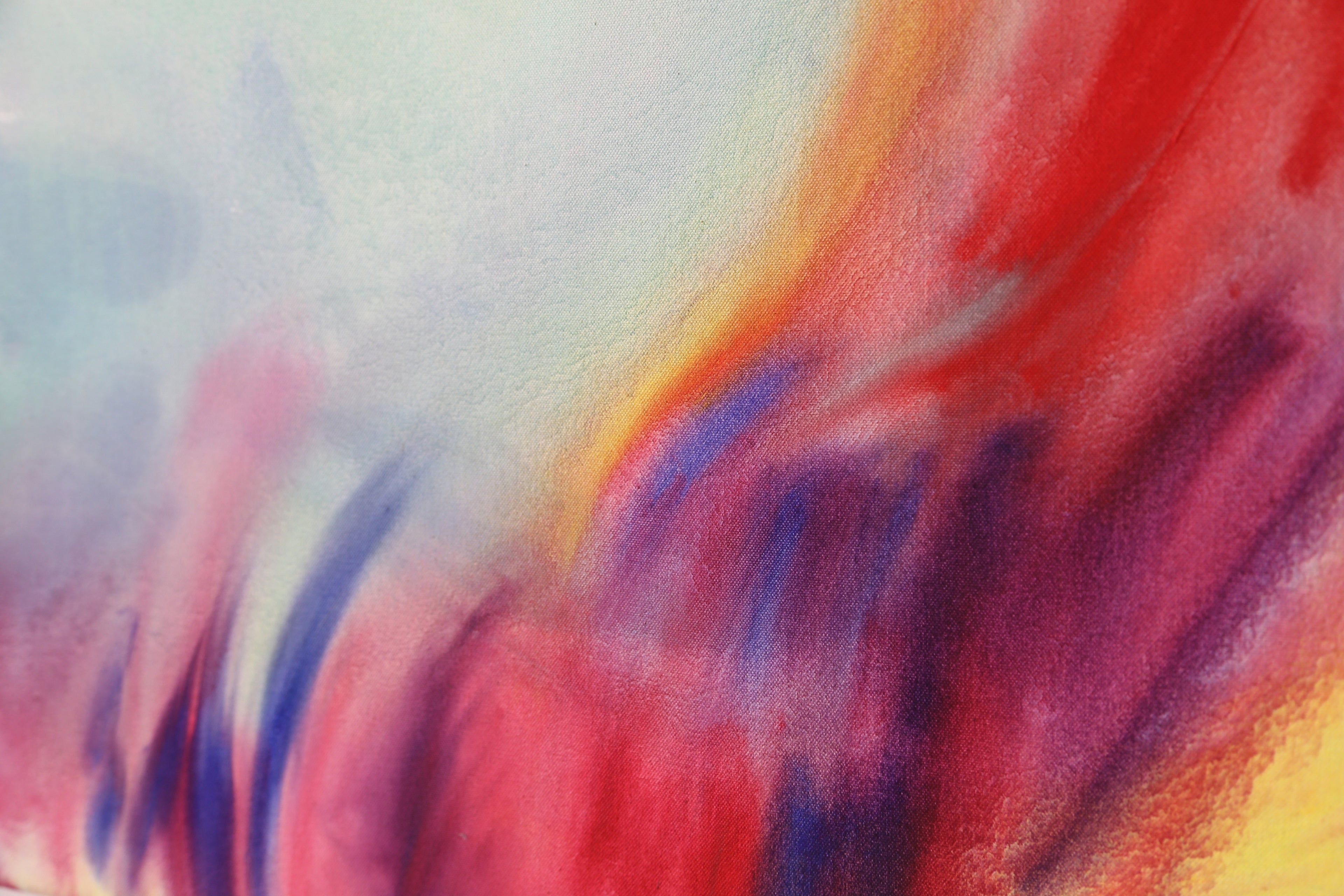 Detail of an abstract painting by Evgenia Makarova. Soft washes of red, pink and blue bleeding across raw canvas.